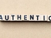 wooden-letter-blocks-on-beige-background-spelling-authentic