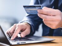 a person uses credit card for online shopping