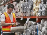 Image of worker examining product
