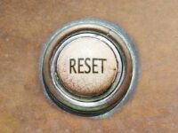 Button with the word "reset" on it set into brown surface