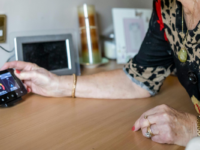 Elderly woman using smart meter