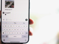 Close-up of a hand holding a phone with a ChatGPT conversation open