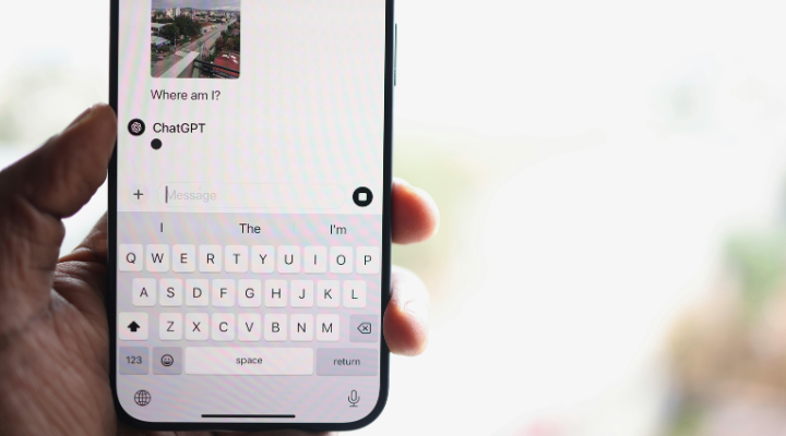 Close-up of a hand holding a phone with a ChatGPT conversation open