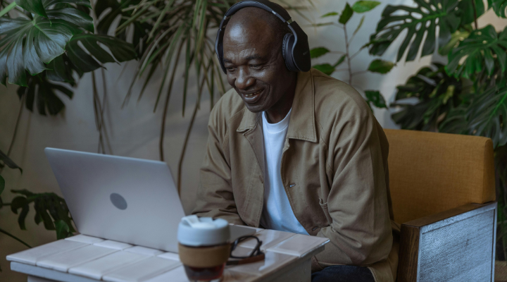 A man grinning down at a computer