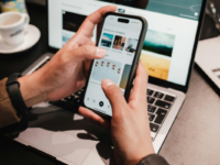 Man using phone and laptop