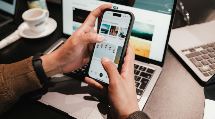 Man using phone and laptop