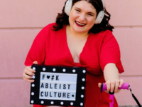 Paris Zarmairian holds anti-ableism sign