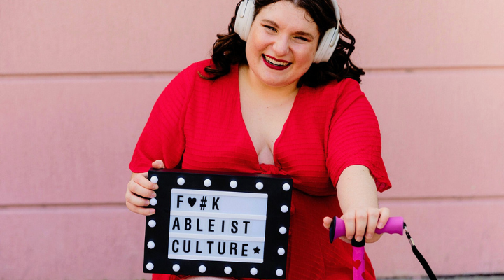 Paris Zarmairian holds anti-ableism sign