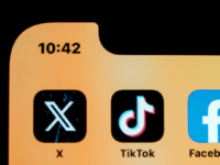 Social media apps on phone screen.