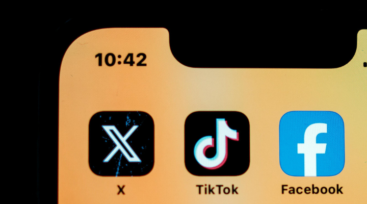 Social media apps on phone screen.