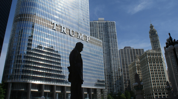Silhouette of a statue outside a Trump tower