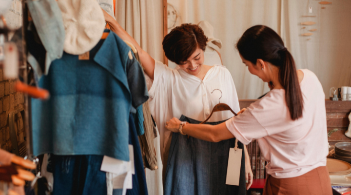 Trying on clothes in a retail fashion store.