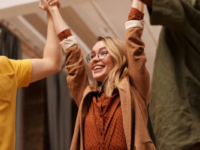 woman-man-grinning-cheering-celebrating-office