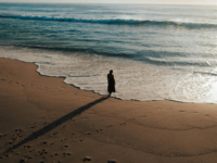 person-standing-at-shoreline-on-beach