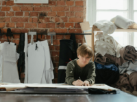 A woman designing clothes in a studio.
