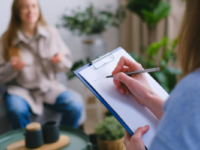 Woman taking notes about client
