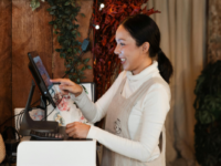 Woman in apron working till in retail store